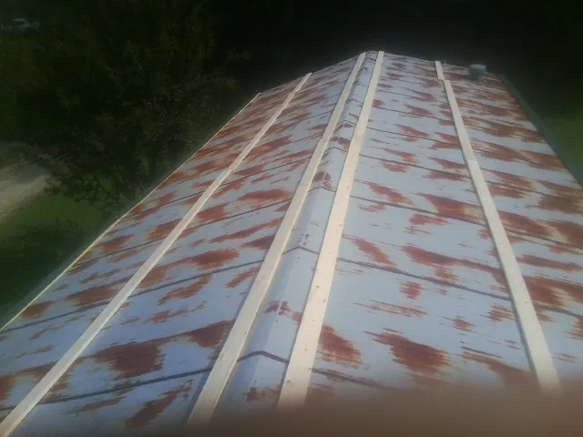 Rusted metal roof panels with new wood purlins before replacement — Storm Damage Roof Repair in Contoocook by Roofing Brothers