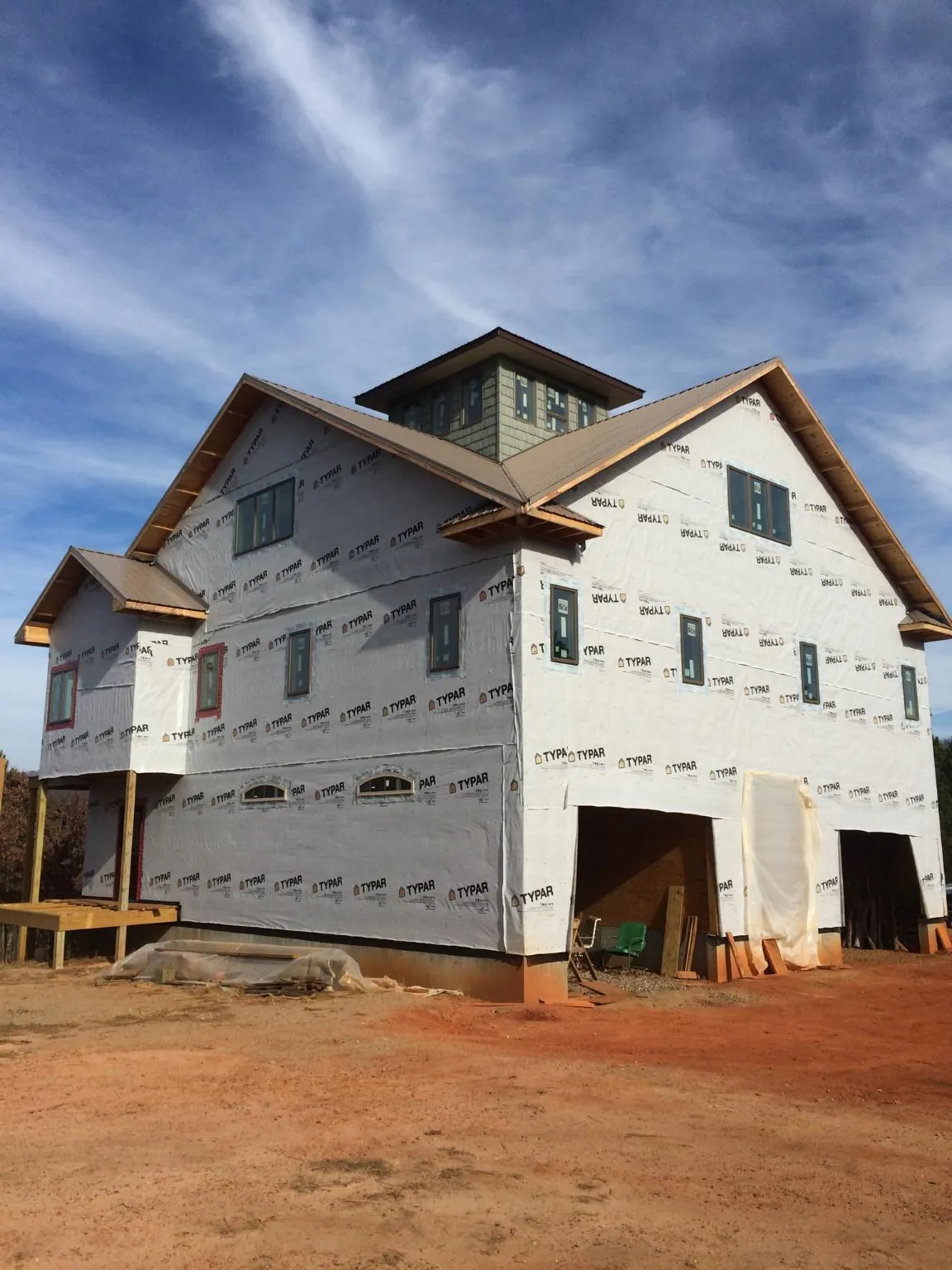 New two story house under construction with a cupola and gabled roofs in Contoocook
